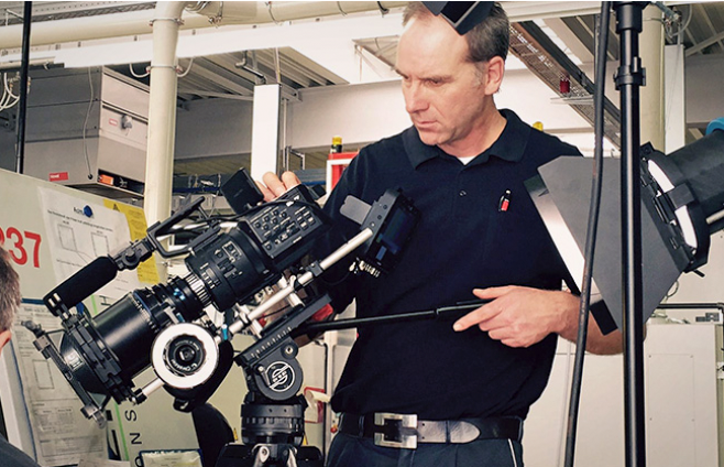 Person stands at a high-speed camera and operates it
